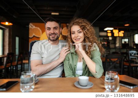 Young couple smiling and posing in a restaurant Young couple smiling and posing in a restaurant 131648695