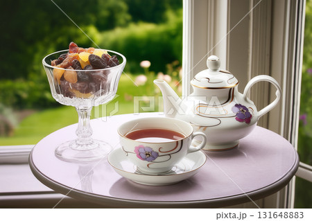 Elegant Tea Set with Dried Fruits by a Sunny Window. Elegant Tea Set with Dried Fruits by a Sunny Window. 131648883