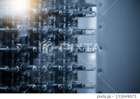 Close up scene of injection process group of preform shape of PET bottle products in the blue scene Close up scene of injection process group of preform shape of PET bottle products in the blue scene 131649073