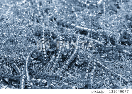 Close up scene scrap material pile from turning process in the light blue tone. Close up scene scrap material pile from turning process in the light blue tone. 131649077