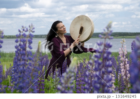 Shaman woman drumming among the flowers Shaman woman drumming among the flowers 131649245