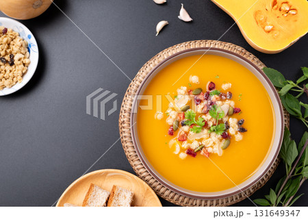 Top view of Butternut squash pumpkin soup with granola, Homemade food in autumn season Top view of Butternut squash pumpkin soup with granola, Homemade food in autumn season 131649347