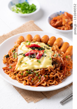 Korean spicy instant noodles with kimchi, sausage and Mozzarella cheese Korean spicy instant noodles with kimchi, sausage and Mozzarella cheese 131649352
