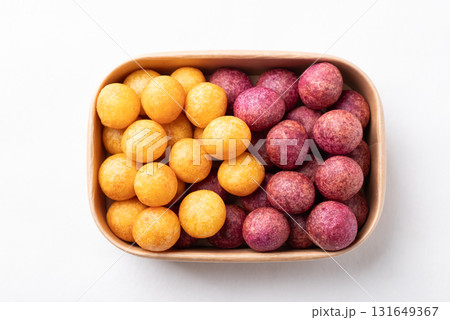 Top view of deep fried sweet potato balls in paper box on white background, Thai street food Top view of deep fried sweet potato balls in paper box on white background, Thai street food 131649367
