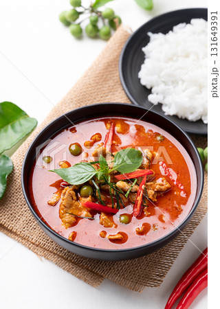 Thai red curry with pork and cooked rice with ingredients on white background Thai red curry with pork and cooked rice with ingredients on white background 131649391