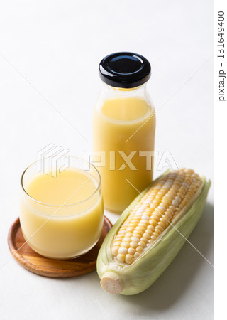 Sweetcorn milk in glass and bottle with fresh sweetcorn, Alternative milk from plant, dairy free Sweetcorn milk in glass and bottle with fresh sweetcorn, Alternative milk from plant, dairy free 131649400