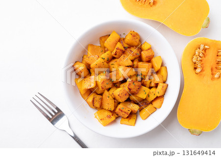 Top view of roasted butternut squash pumpkin in a bowl on white background, Autumn homemade food Top view of roasted butternut squash pumpkin in a bowl on white background, Autumn homemade food 131649414