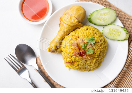 Top view of Thai Biryani rice with chicken and chili sauce on white background Top view of Thai Biryani rice with chicken and chili sauce on white background 131649423