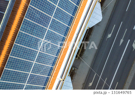 Aerial view of solar photo voltaic panels system on apartment building roof. Renewable ecological green energy production concept. 131649765