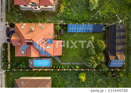 Aerial view of rural residential area with private homes between green fields at sunrise. 131649798