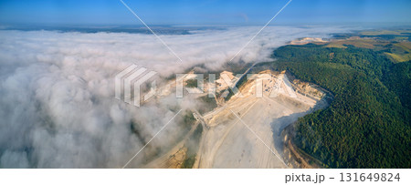Aerial view of open pit mining site of limestone materials extraction for construction industry with excavators and dump trucks. 131649824