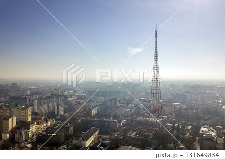 Aerial view of modern city urban foggy landscape with tall television tower on bright blue sky copy space background at dawn. Drone photography. 131649834