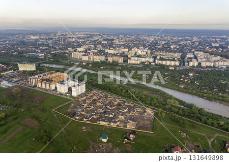 Aerial view of Ivano-Frankivsk city with residential area and suburb houses with a river in middle. Aerial view of Ivano-Frankivsk city with residential area and suburb houses with a river in middle. 131649898