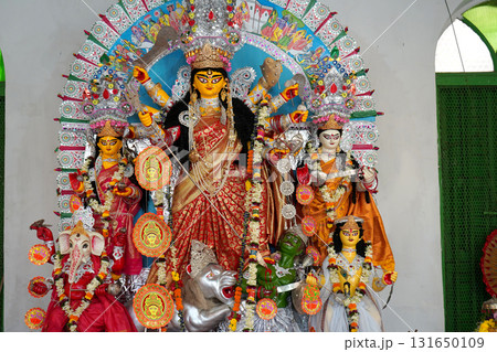 Traditional Bengali Durga Idol with Family and Colorful Foil Decorative Backdrop 131650109