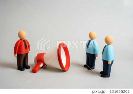 A businessman uses a megaphone to persuade other employees. Attracting investors and clients. Concept of leadership, influence, motivation, and corporate communication strategy. 131650202