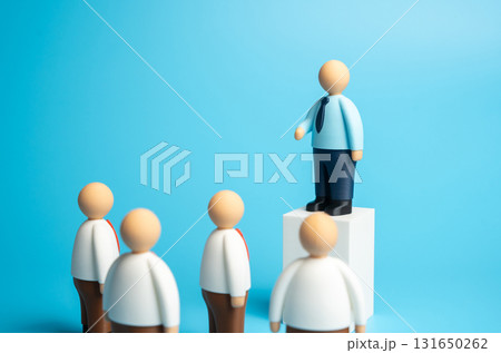 A politician stands at the podium delivering a speech to the assembled crowd. A business leader addresses his subordinates. Concept of leadership, public speaking, influence A politician stands at the podium delivering a speech to the assembled crowd. A business leader addresses his subordinates. Concept of leadership, public speaking, influence 131650262