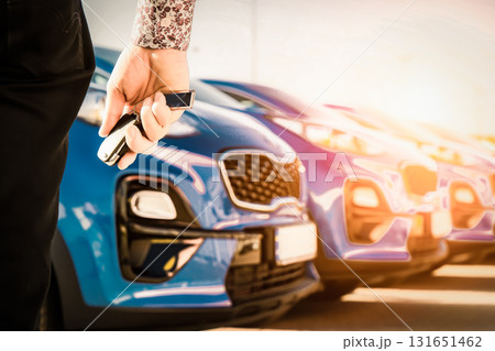 transportation and ownership concept - customer and salesman with car key outside transportation and ownership concept - customer and salesman with car key outside 131651462