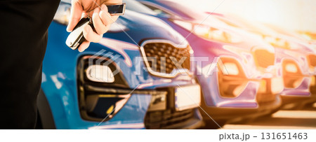 transportation and ownership concept - customer and salesman with car key outside 131651463