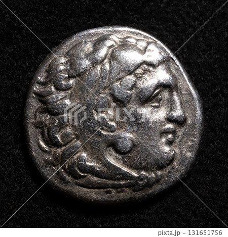 Ancient Greek coin of Alexander the Great with head of Hercules in lion skin, vintage silver drachma, textured metal money Ancient Greek coin of Alexander the Great with head of Hercules in lion skin, vintage silver drachma, textured metal money 131651756