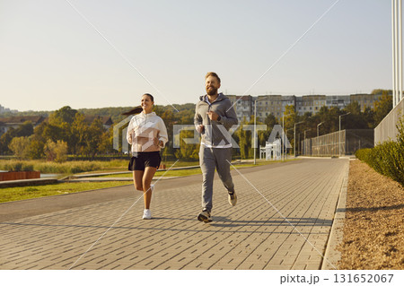 Couple jogging in the park having sport workout in nature together. Healthy lifestyle concept. 131652067