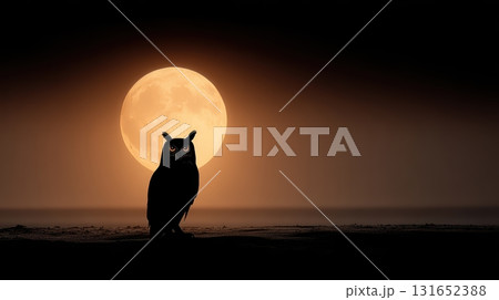 Majestic Owl Silhouetted Against Golden Full Moon at Night 131652388