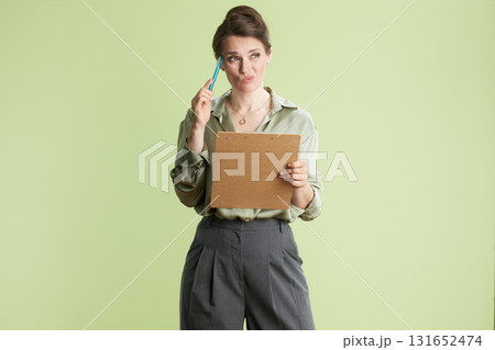 Woman deep in thought, hand to temple 131652474