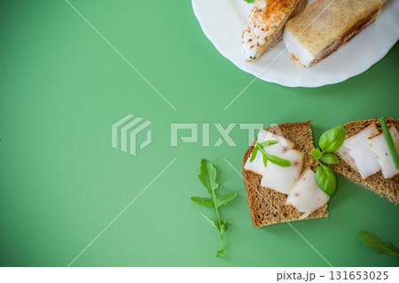 Black bread with lard and onions - top view, isolated 131653025