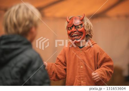 Child joyfully plays while throwing beans at parent in a fun setting 131653604