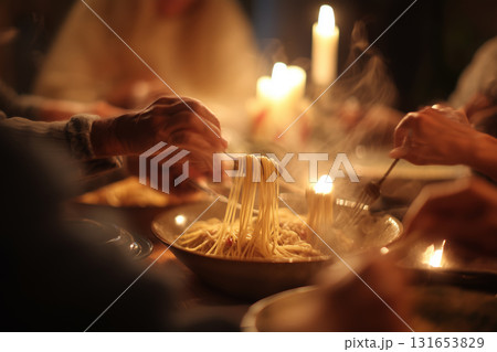 Twirling spaghetti at a cozy family dinner in soft candlelight Twirling spaghetti at a cozy family dinner in soft candlelight 131653829