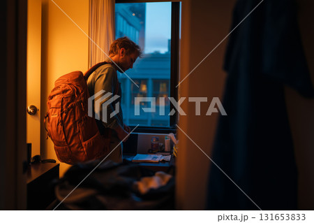 Freelancer finishing work and packing for the day in a cozy space 131653833