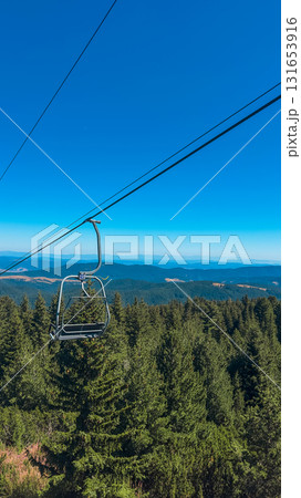 Chair Lift above the mountains and green forest of Bulgaria. Eco tourism. Tourist attraction. Seven Rila lakes. Cable car in Rila Mountains 131653916