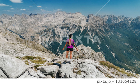 Woman Standing on Mountain Summit in Albanian Alps 131654129