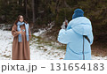 Winter bloggers capture memories in a snowy forest with their smartphones 131654183