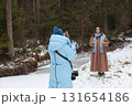 Winter bloggers capturing moments in a snowy forest landscape 131654186