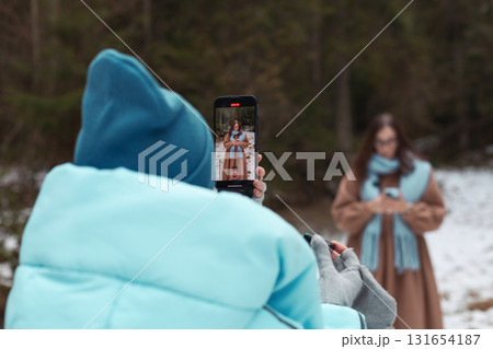 Winter bloggers capture stylish moments in a snowy forest setting 131654187