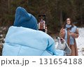 Bloggers recording video with a smartphone in the snowy lawn. 131654188