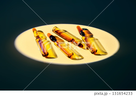 Several ampoules in the spotlight on a beige background. 131654233