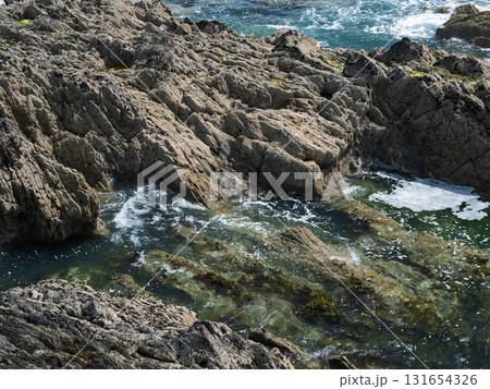 The landscape of West Cork, Ireland, is beautiful. It has a rocky coastline and clear waters. 131654326
