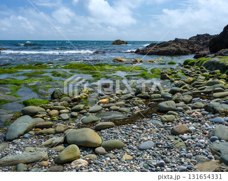 Picturesque view of ocean meeting rugged shoreline. 131654331