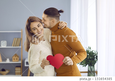 Happy young people hugging and kissing on a romantic Valentine's Day date at home Happy young people hugging and kissing on a romantic Valentine's Day date at home 131654385