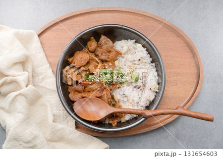 Jeyukdeopbap, Korean Food Spicy Stir-fried Pork with Rice in Black Bowl  131654603