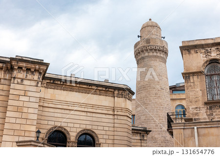 Beige stone building featuring a tall cylindrical minaret, Baku, Azerbaijan 131654776
