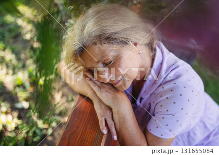 Selfacare moment for elderly woman, quiet time in garden. Selfacare moment for elderly woman, quiet time in garden. 131655084