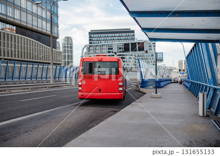 Red city bus on road in modern city. Red city bus on road in modern city. 131655133