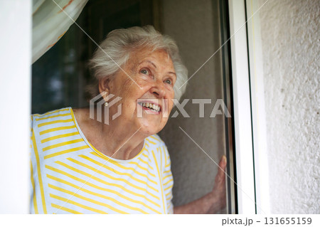 Cute old lady on balcony. Cute old lady on balcony. 131655159