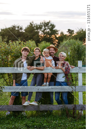 Farmer family portrait. Prents with three kids. 131655171