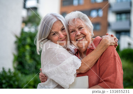 Portrait of beautiful adult daughter with old mother. Portrait of beautiful adult daughter with old mother. 131655231