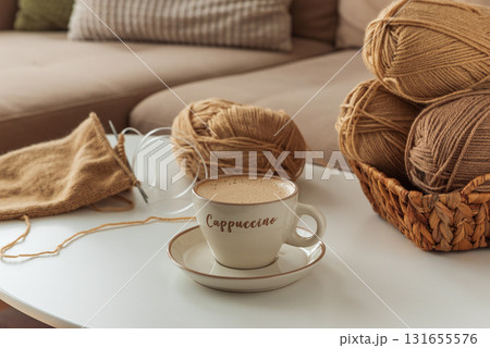Knitting Project with Cup of Cappuccino on White Table in Cozy Setting 131655576