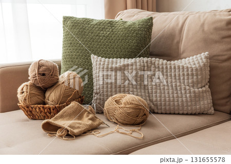 Knitting Basket with Yarn and Velvet Pumpkins in Cozy Autumn Sofa 131655578
