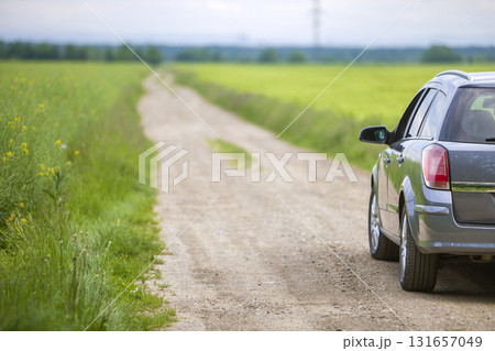 A car on dirt road in green field. A car on dirt road in green field. 131657049